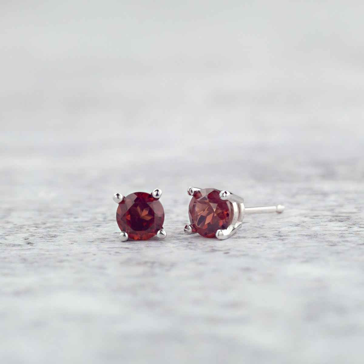 4mm Garnet Stud Earrings in 14K White Gold front view