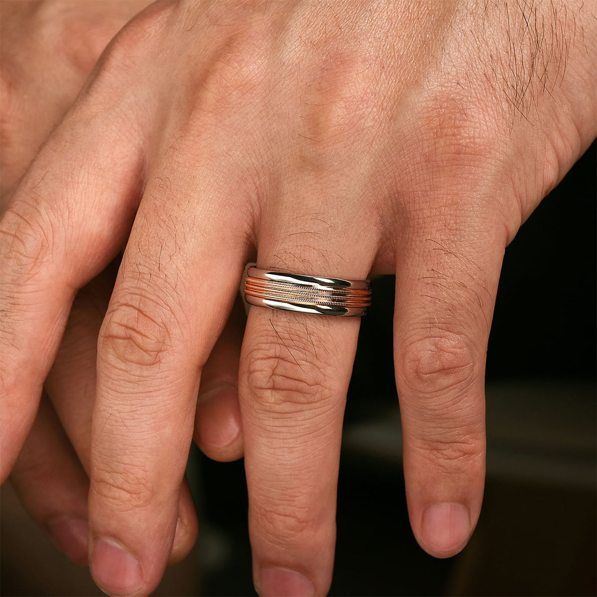 Gabriel & Co. Ethan Men's 7mm Rope Textured Polished Edge Wedding Ring in 14k Pink & White Gold close-up detail