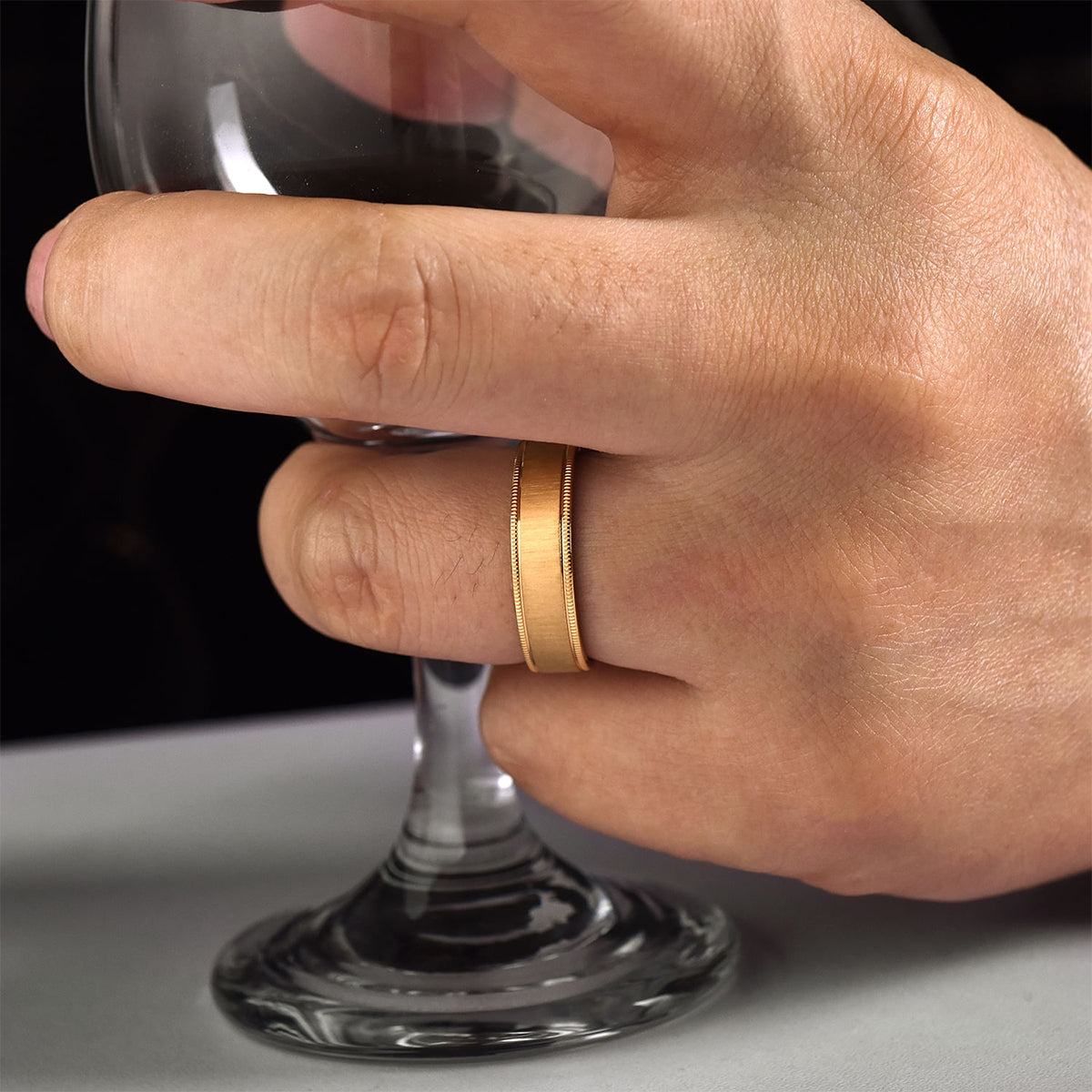 Gabriel & Co. Jason Men's 6mm Sandblast Finish Milgrain Edge Wedding Ring in 14K Yellow Gold close-up detail