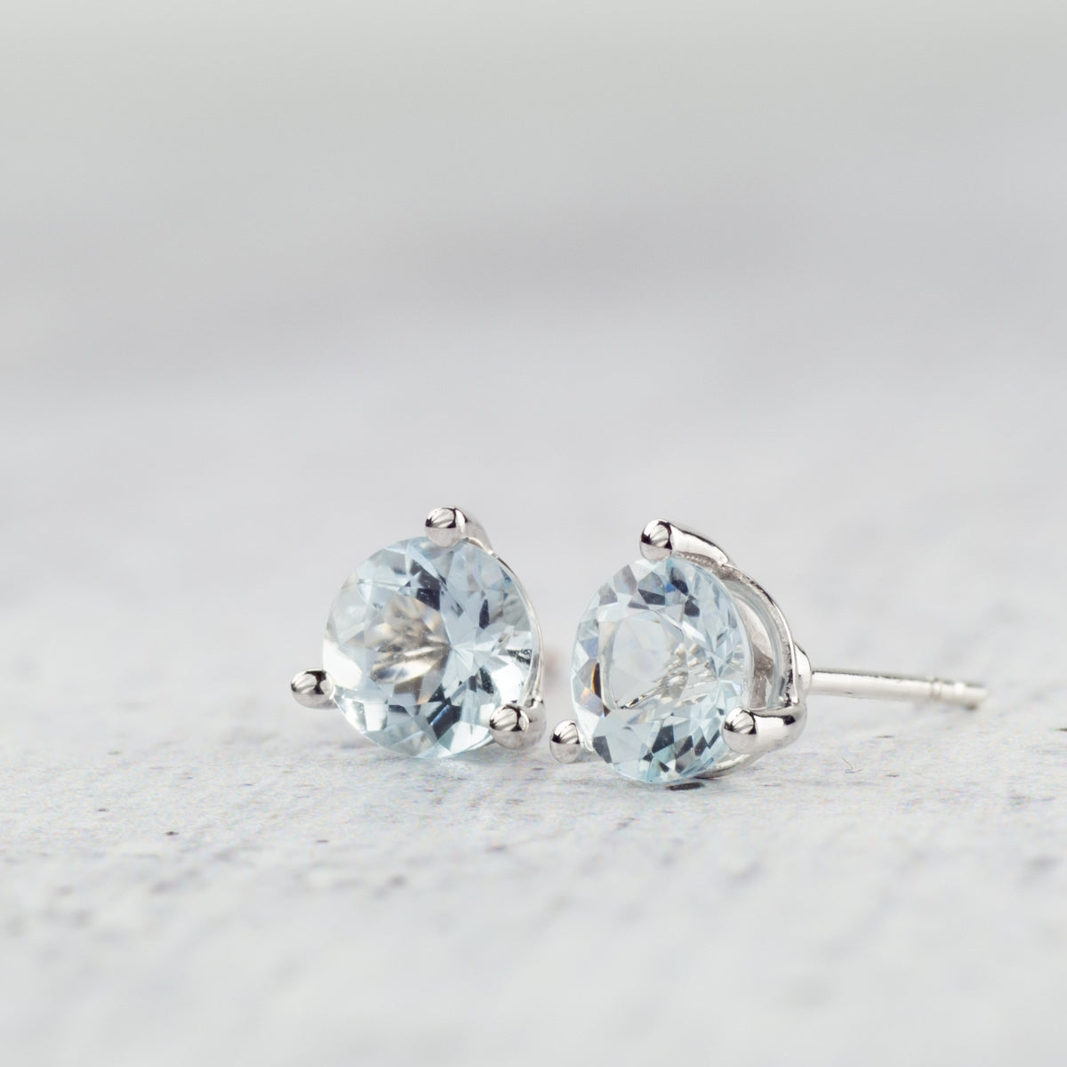 6mm Round Aquamarine Stud Earrings in 10K White Gold side profile