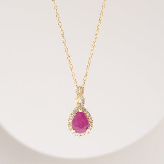 Infinite Love Pear Ruby & 1/10 ct. tw. Diamond Halo Twist Pendant in 10K Yellow Gold front view