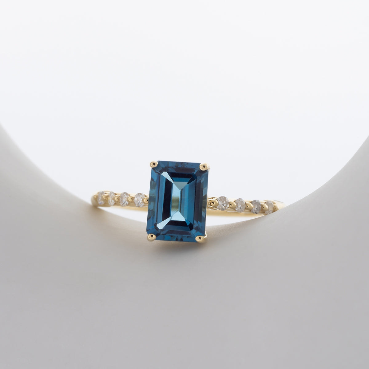 Emerald Cut London Blue Topaz & 1/8 ct. tw. Diamond Ring in 10K Yellow Gold close-up detail