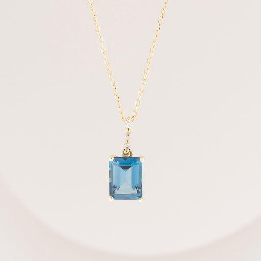 Emerald Cut London Blue Topaz & Diamond Accent Pendant in 10K Yellow Gold front view