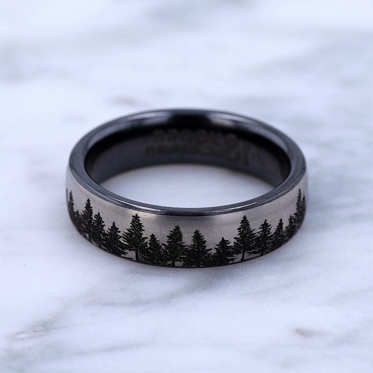 Men's 6.5mm Tree Line Wedding Ring in Black Titanium close-up detail