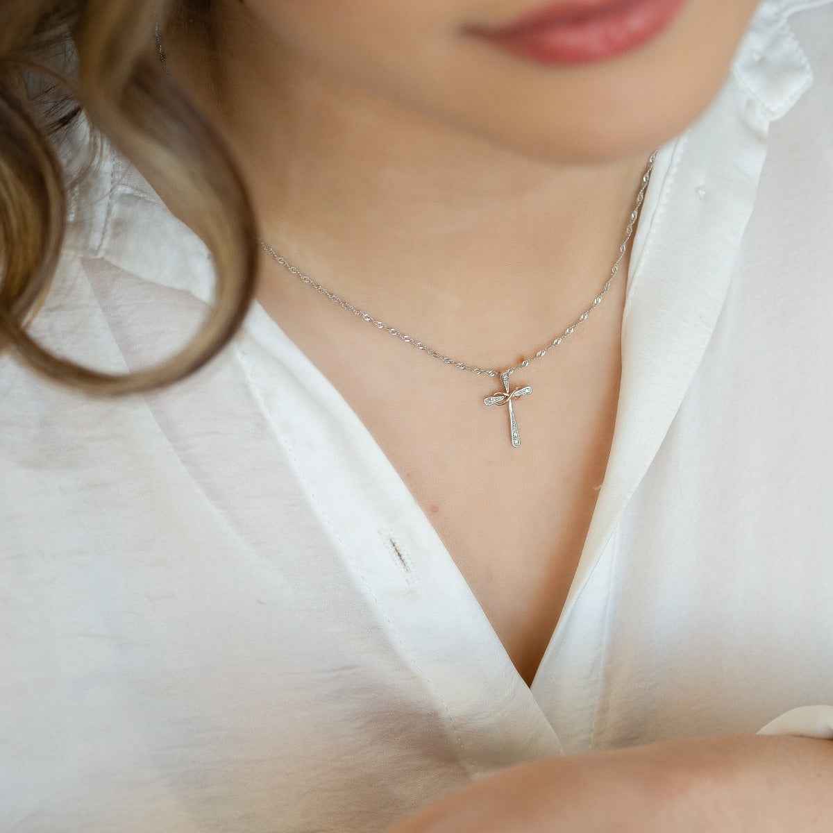.025 ct. tw. Diamond Cross Pendant with 10K Pink Gold Infinity-Design Ribbon in Sterling Silver front view