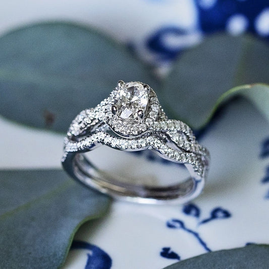 Natural 1 ct. tw. Oval Diamond Halo Twist Wedding Set in 14K White Gold angled view