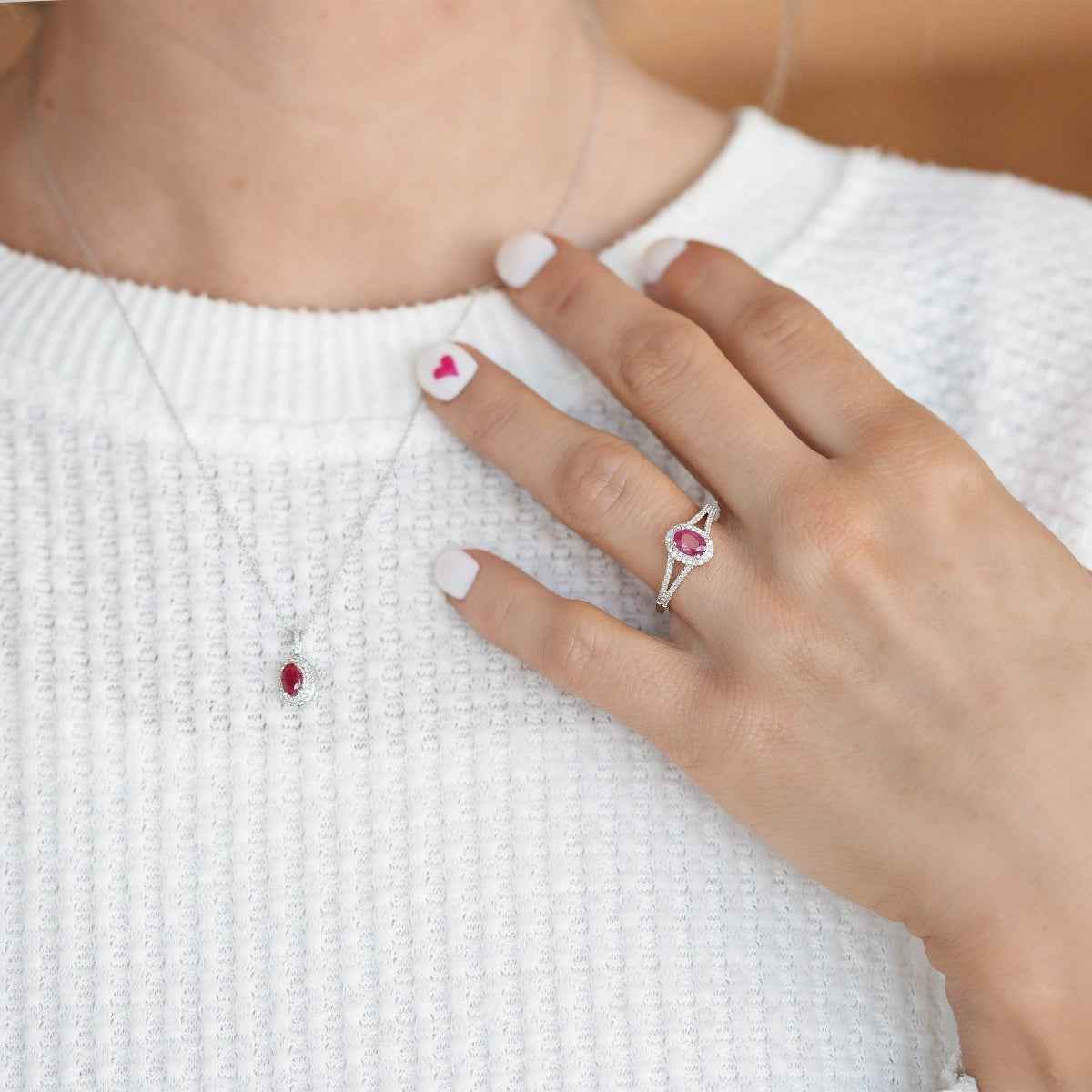 Genuine Oval Ruby Ring with 1/6 ct. tw. Diamond Halo & Split-Shank Band with Milgrain Edging in 10K White close-up detail