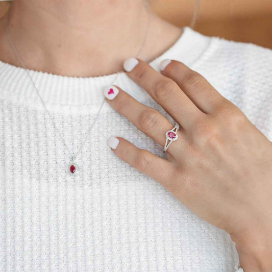 Genuine Oval Ruby Ring with 1/6 ct. tw. Diamond Halo & Split-Shank Band with Milgrain Edging in 10K White close-up detail