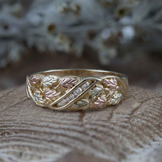 Black Hills Gold Men's 1/8 ct. tw. Diamond Diagonal Channel Set Wedding Ring in 10K Yellow Gold close-up detail