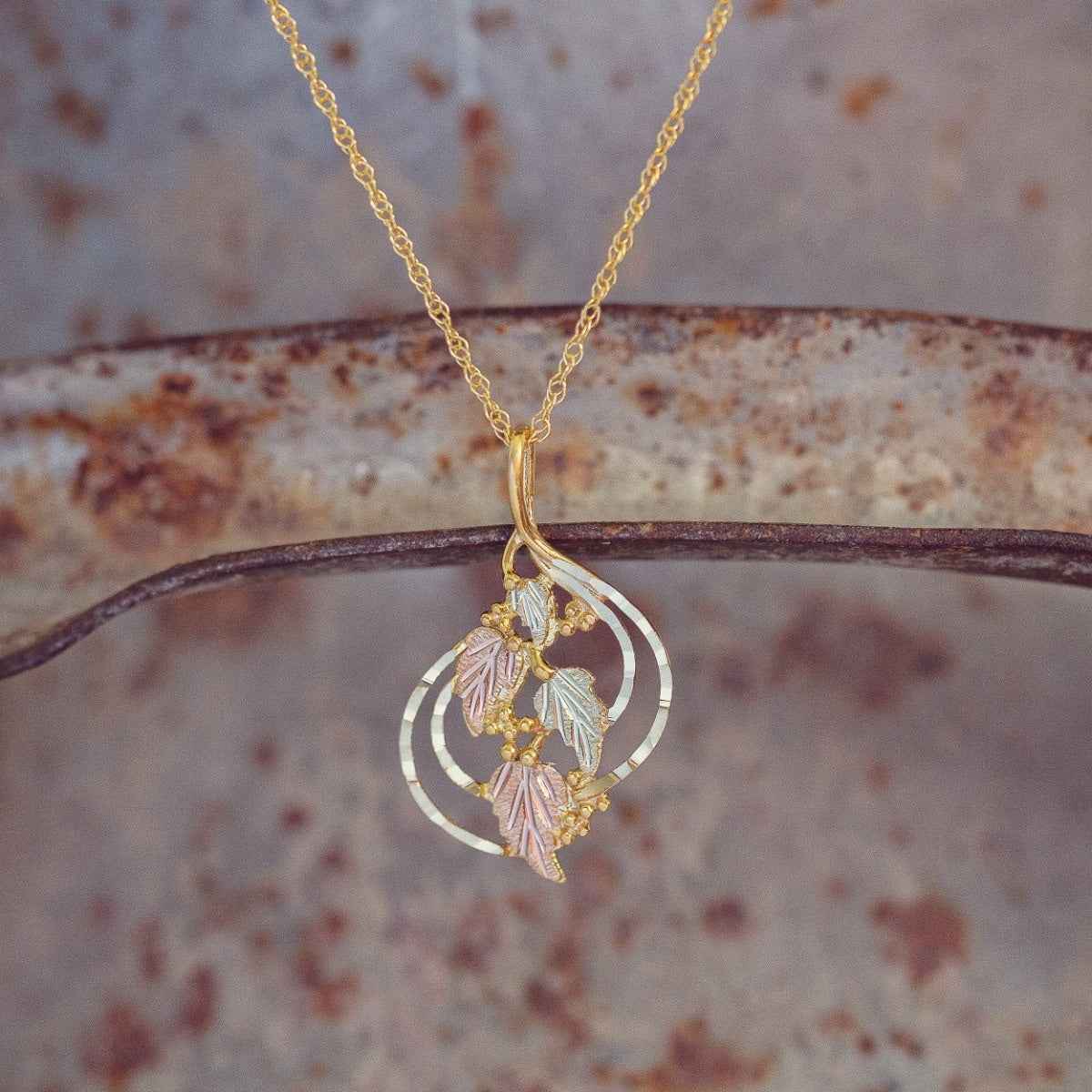 Black Hills Gold Ladies' Hanging Grape Vine & Leaf Pendant with Hammered Gold Detailing in 10K Yellow Gold front view
