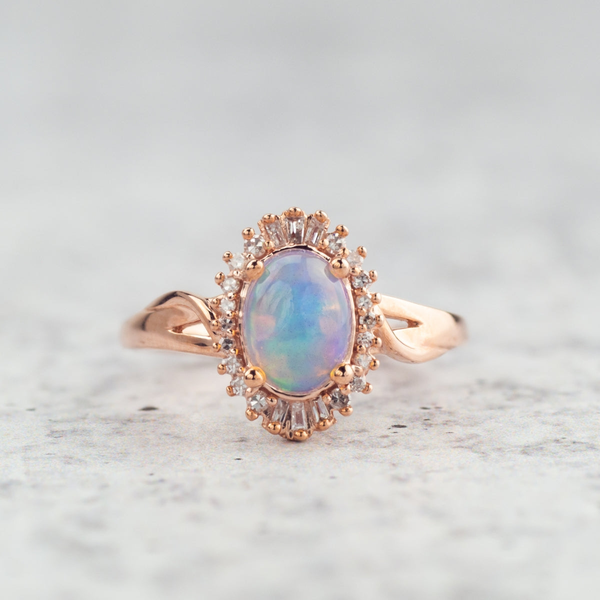 Impulse Collection Oval Opal & 1/8 ct. tw. Round & Tapered Baguette Diamond Halo Ring in 10K Pink Gold front view