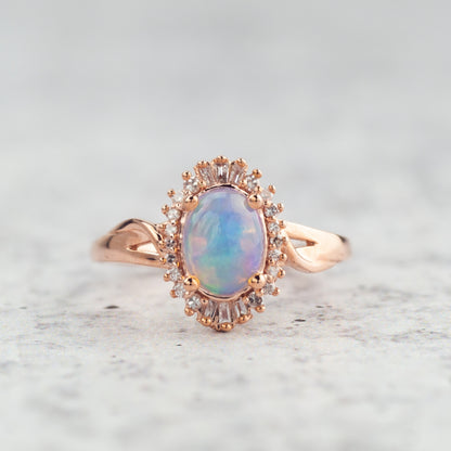 Impulse Collection Oval Opal & 1/8 ct. tw. Round & Tapered Baguette Diamond Halo Ring in 10K Pink Gold front view