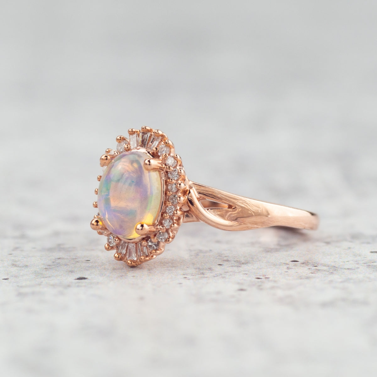Impulse Collection Oval Opal & 1/8 ct. tw. Round & Tapered Baguette Diamond Halo Ring in 10K Pink Gold close-up detail