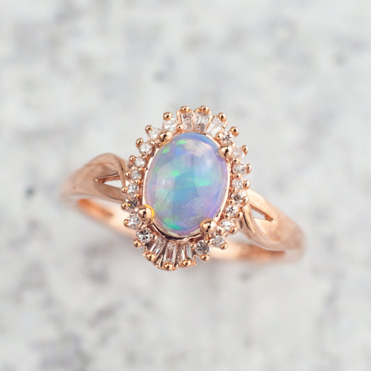 Impulse Collection Oval Opal & 1/8 ct. tw. Round & Tapered Baguette Diamond Halo Ring in 10K Pink Gold side profile