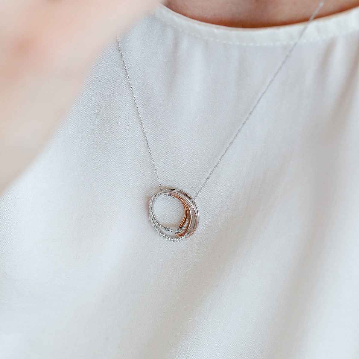 1/6 ct. tw. Diamond Cirlce Pendant in 10K Pink Gold and Sterling Silver front view