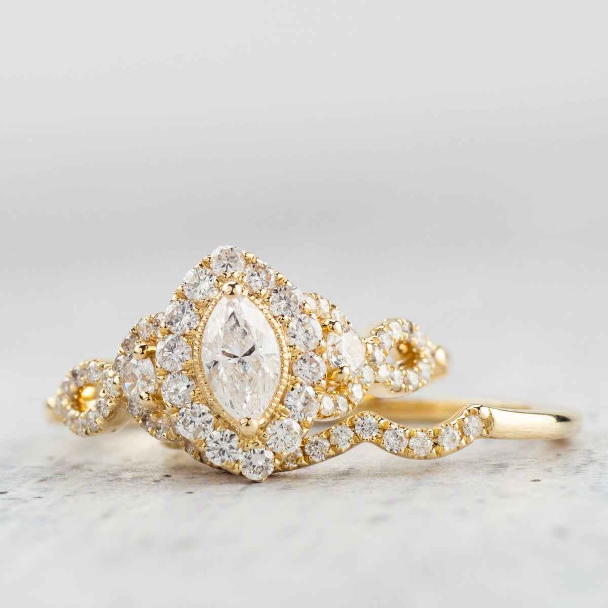 Natural 1-1/5 ct. tw. Marquise & Round Diamond Halo Twist Wedding Set in 14K Yellow Gold front view