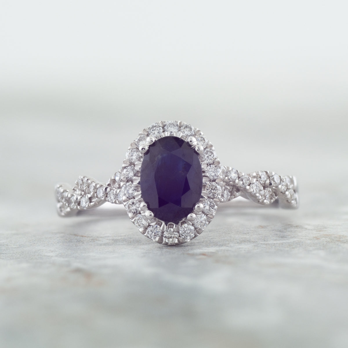 Genuine Oval Blue Sapphire Fashion Ring with 1/3 ct. tw. Diamond Halo & Twist Band in 10K White Gold close-up detail
