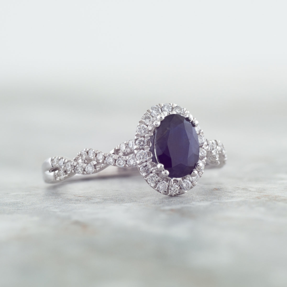 Genuine Oval Blue Sapphire Fashion Ring with 1/3 ct. tw. Diamond Halo & Twist Band in 10K White Gold side profile