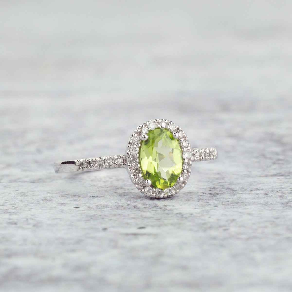 Genuine Oval Peridot Fashion Ring with 1/8 ct .tw. Diamond Halo & Band in 10K White Gold close-up detail
