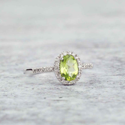 Genuine Oval Peridot Fashion Ring with 1/8 ct .tw. Diamond Halo & Band in 10K White Gold close-up detail