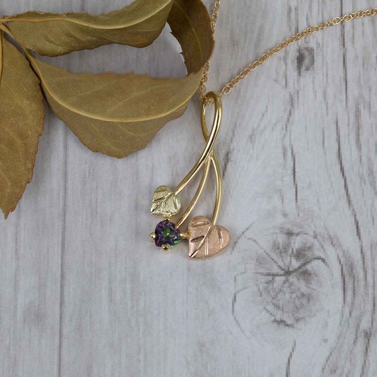 Black Hills Gold Heart Mystic Fire Topaz & Double Leaf Pendant in 10K Yellow Gold front view
