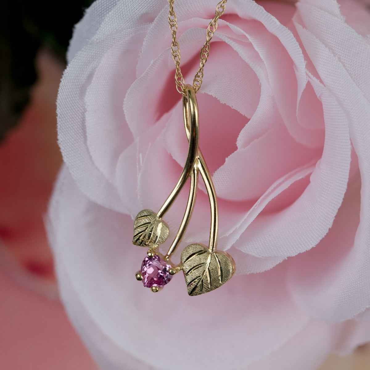 Black Hills Gold Created Heart Pink Sapphire & Double Green Leaf Pendant in 10K Yellow Gold front view