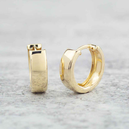 Shiny Huggie Hoop Earrings in 10K Yellow Gold front view