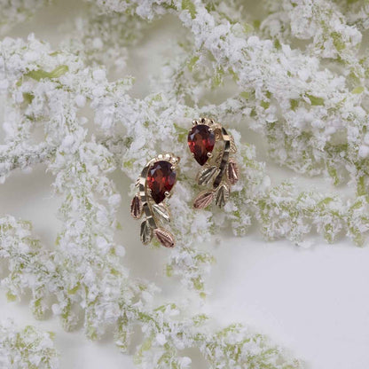 Black Hills Gold Pear Garnet & Leaf Branch Earrings in 10K Yellow Gold front view