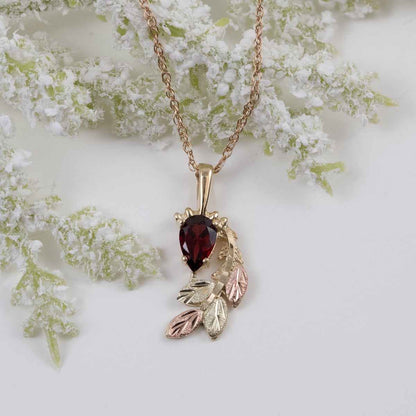 Black Hills Gold Pear Garnet & Leaf Branch Pendant in 10K Yellow Gold front view