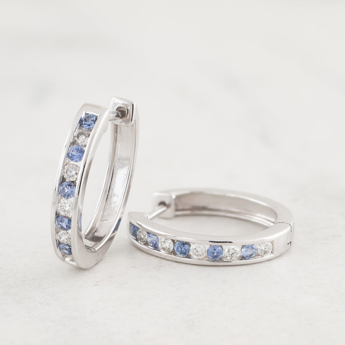 Yogo Sapphire & 1/4 ct. tw. Diamond Channel Set Hoop Earrings in 10K White Gold front view