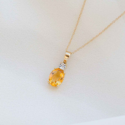 Oval Citrine & Miracle Plate Diamond Accent Pendant in 10K Yellow Gold front view