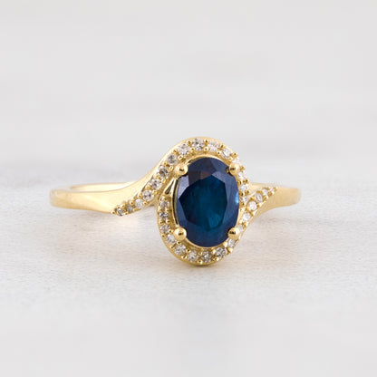 Oval Sapphire & 1/10 ct. tw. Diamond Bypass Halo Ring in 10K Yellow Gold close-up detail