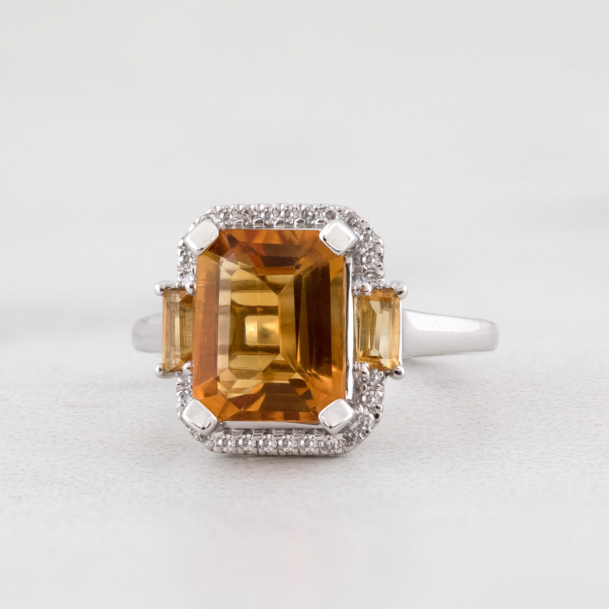 Emerald Cut Madeira Citrine & 1/10 ct. tw. Diamond Halo Ring with Baguette Citrine Accents in 10K White Gold close-up detail