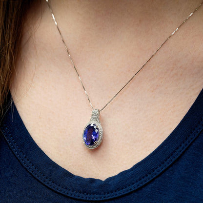 Oval Tanzanite & 1/4 ct. tw. Diamond Halo Pendant in 14K White Gold front view