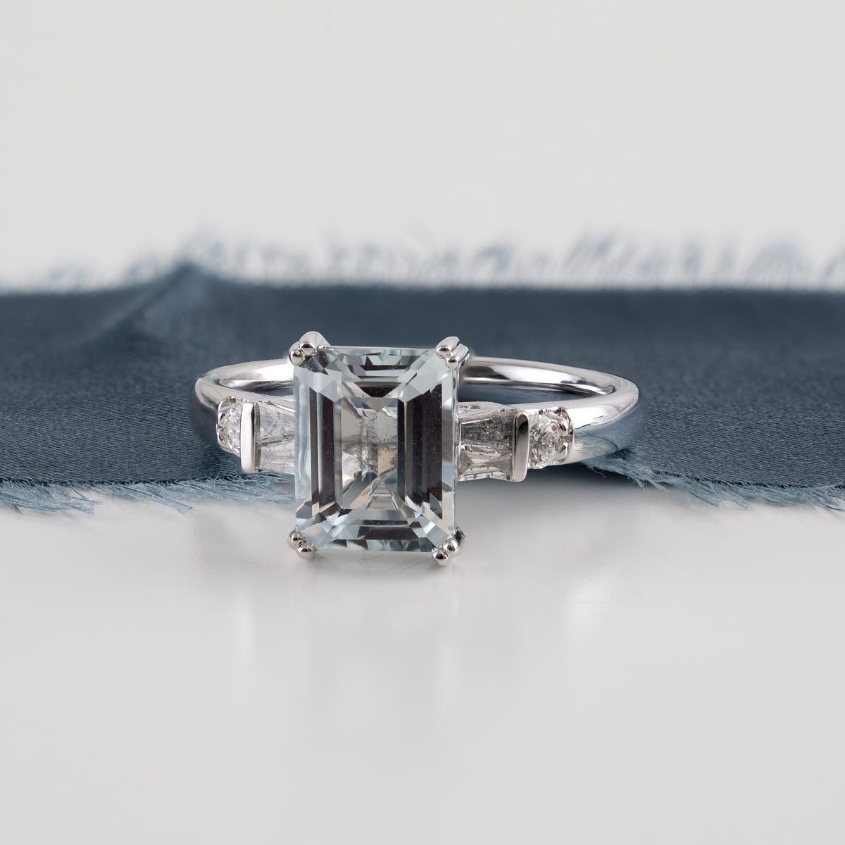 Emerald Cut Aquamarine & 1/4 ct. tw. Baguette & Round Diamond Ring in 14K White Gold close-up detail