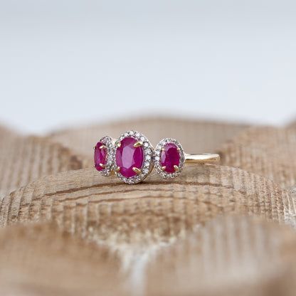 3-Stone Oval Ruby & 1/5 ct. tw. Diamond Halo Ring in 14K Yellow Gold close-up detail