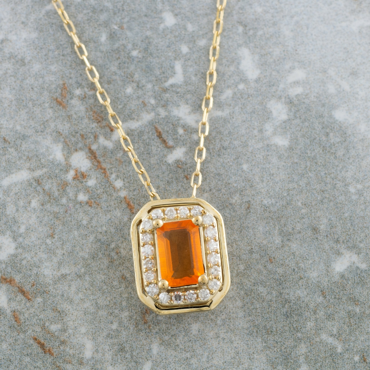 American Colors Emerald Cut Fire Opal & 1/8 ct. tw. Diamond Halo Pendant in 10K Yellow Gold front view