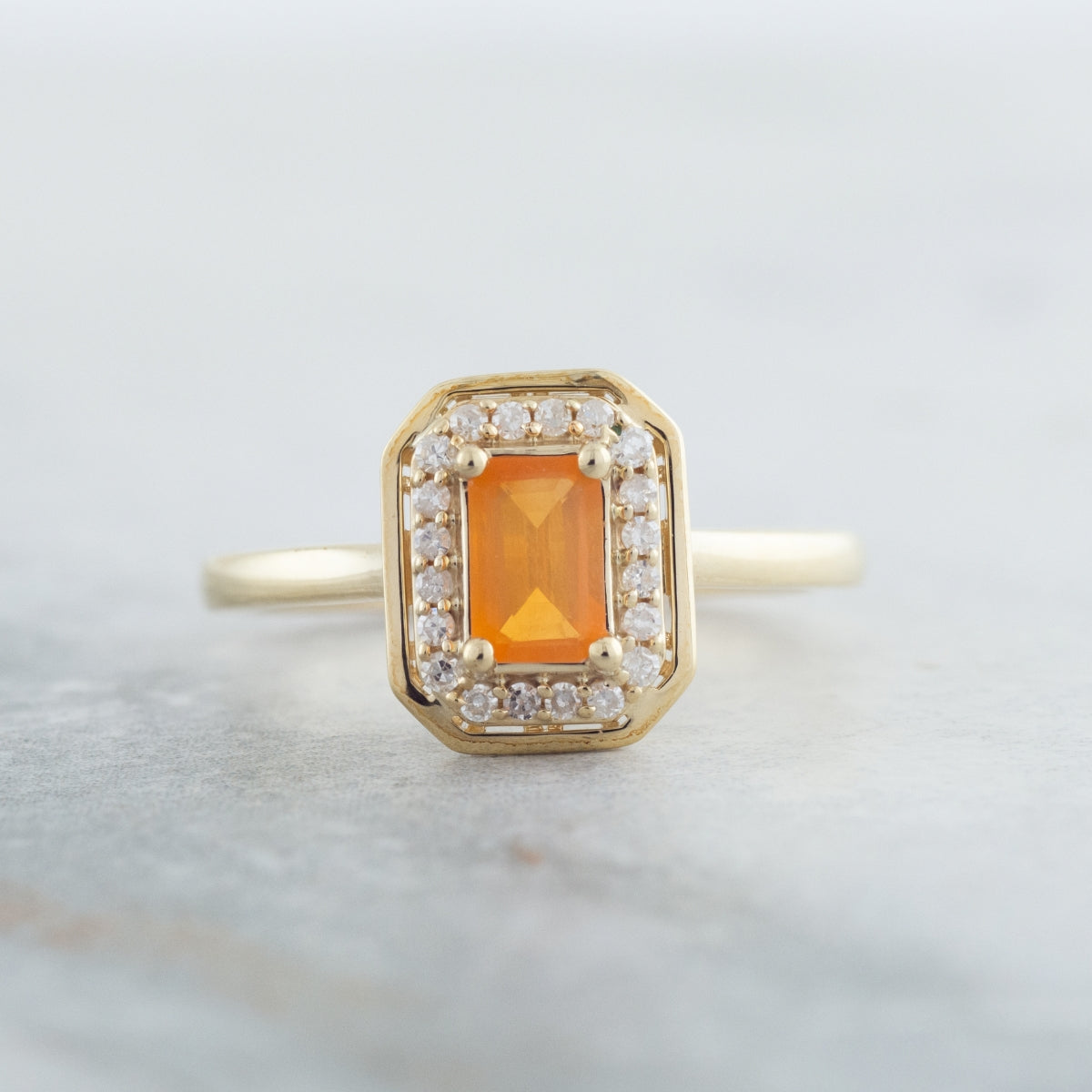 American Colors Emerald Cut Fire Opal & 1/8 ct. tw. Diamond Halo Ring in 10K Yellow Gold close-up detail