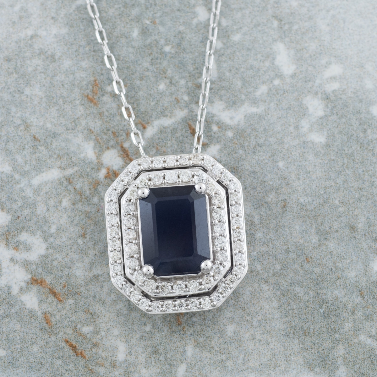 Emerald Cut Sapphire & 1/3 ct. tw. Diamond Double Halo Pendant in 10K White Gold front view