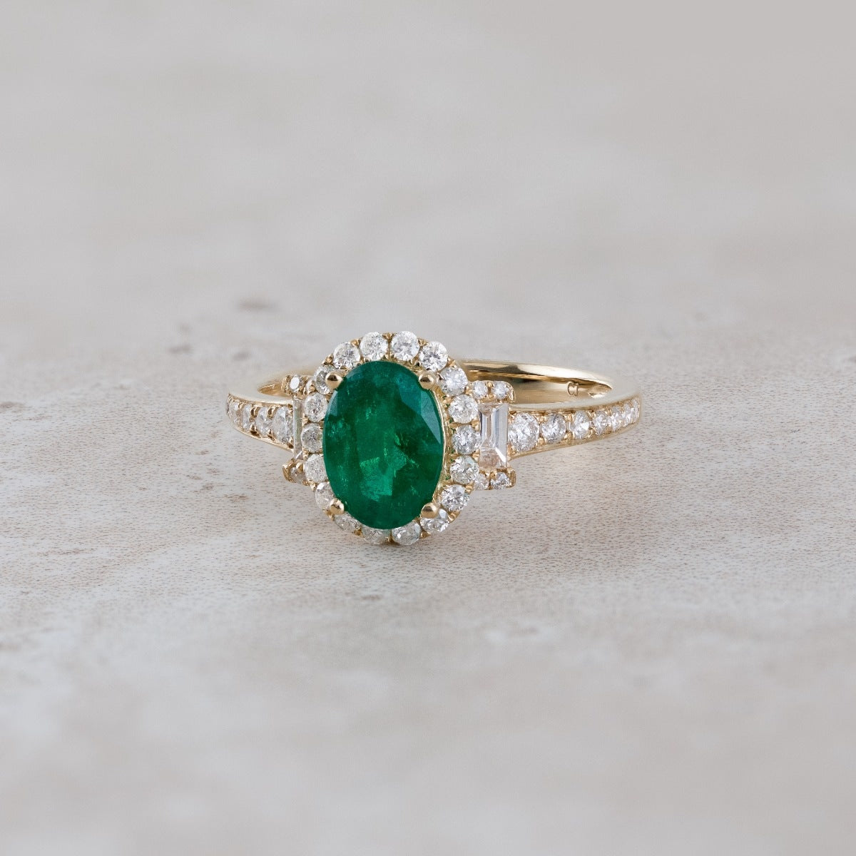 Oval Emerald & 1/2 ct. tw. Round & Baguette Diamond Halo Ring in 18K Yellow Gold close-up detail