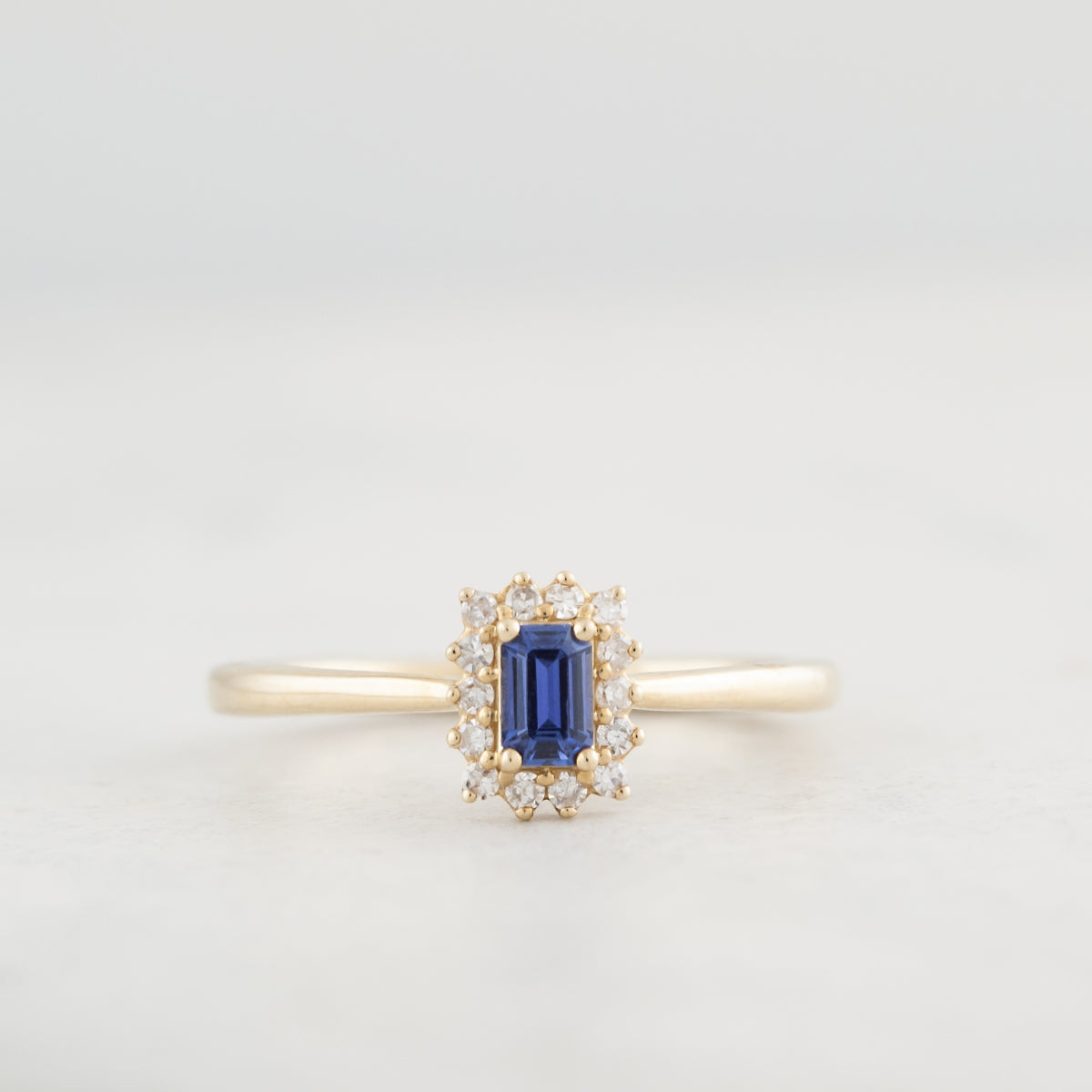 Emerald Cut Yogo Sapphire & 1/10 ct. tw. Diamond Halo Ring in 10K Yellow Gold close-up detail