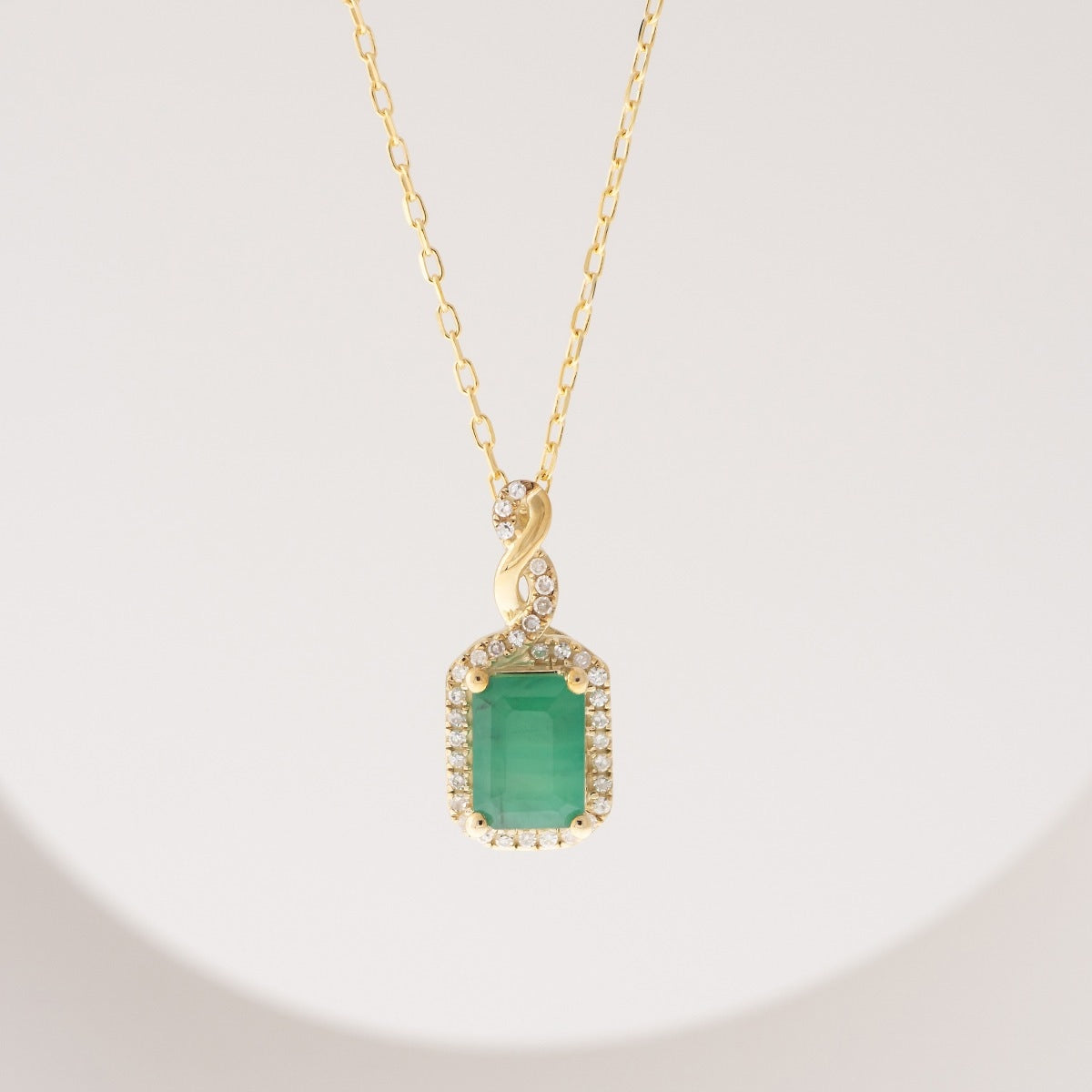 Infinite Love Emerald Cut Emerald & 1/10 ct. tw. Diamond Pendant in 10K Yellow Gold front view