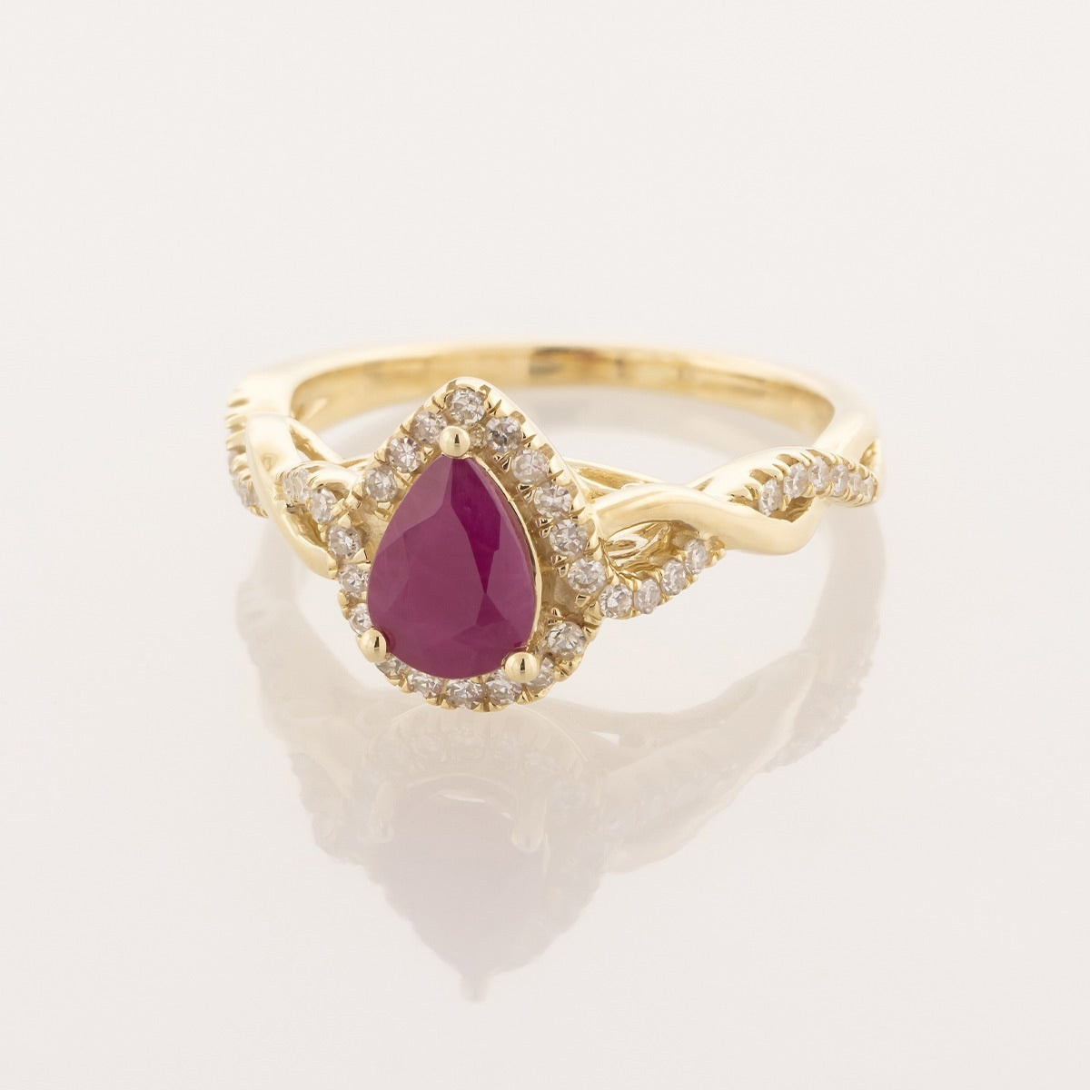 Infinite Love Pear Ruby & 1/5 ct. tw. Diamond Halo Twist Ring in 10K Yellow Gold front view