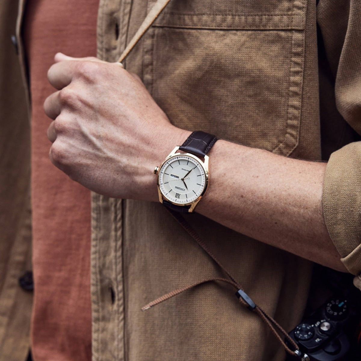Citizen Men's Classic Eco-Drive Rose Gold-Tone Stainless Steel Watch with Ivory Dial & Brown Leather Strap side profile