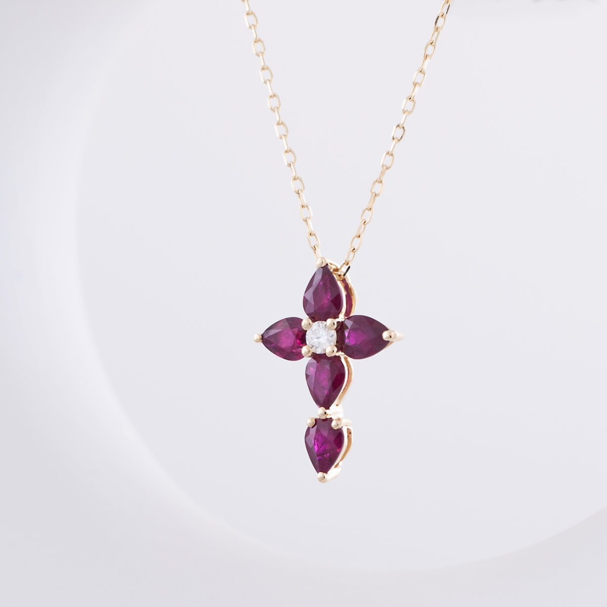 Pear Ruby & Diamond Accent Cross Pendant in 10K Yellow Gold front view