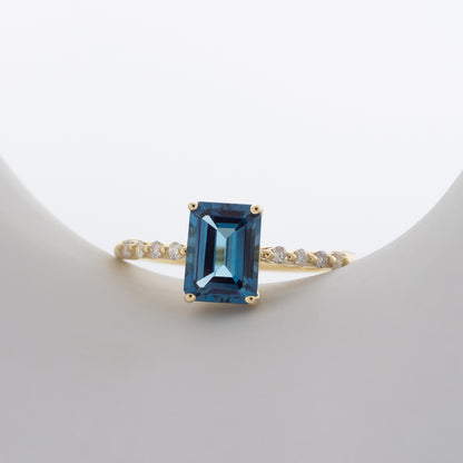 Emerald Cut London Blue Topaz & 1/8 ct. tw. Diamond Ring in 10K Yellow Gold close-up detail