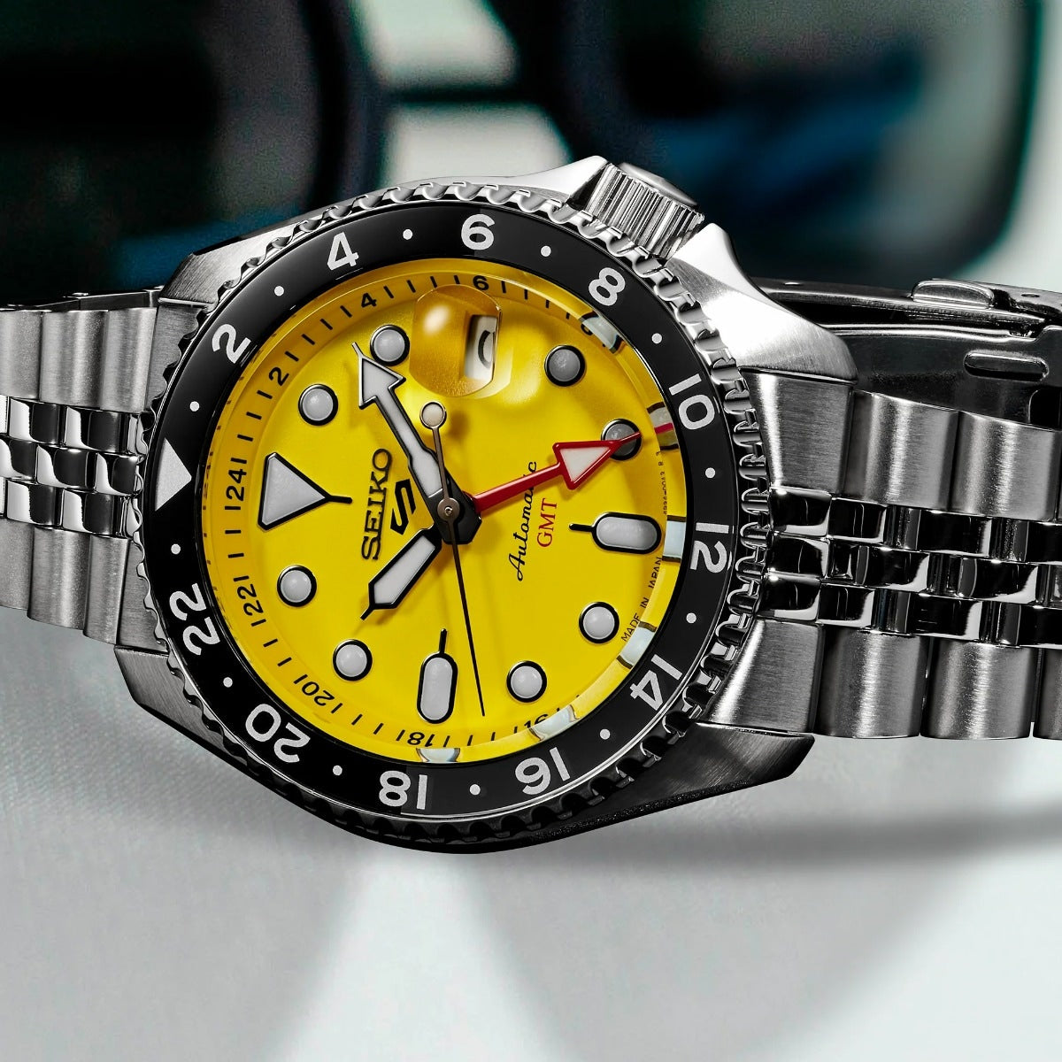 Seiko Men's 5 Sports U.S. Special Creation Automatic Stainless Steel Watch with Yellow Dial & Black & Gray Bezel front view