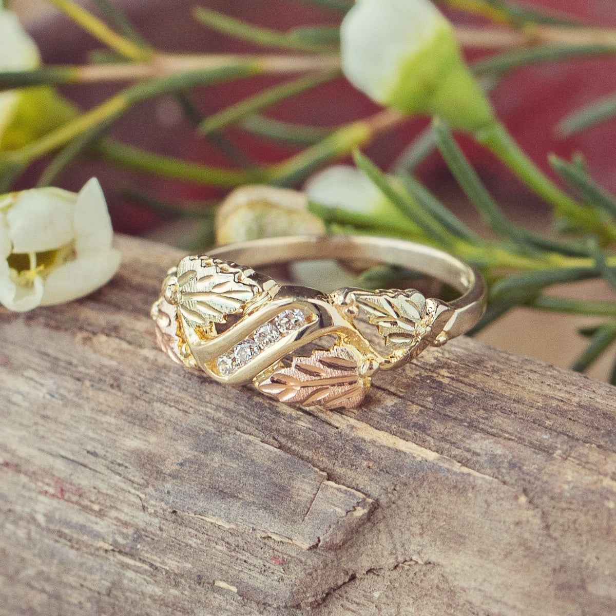 Black Hills Gold 1/8 ct. tw. Round Diamond Channel Set Grapevine & Leaf Anniversary Ring in 10K Yellow Gold close-up detail