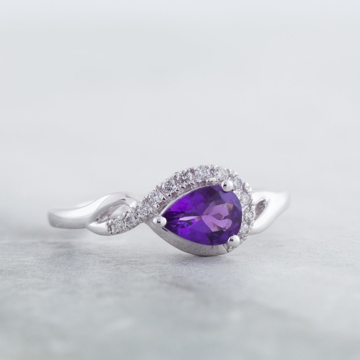 Pear Amethyst & 1/10 ct. tw. Diamond Half Halo Twist Ring in 10K White Gold close-up detail