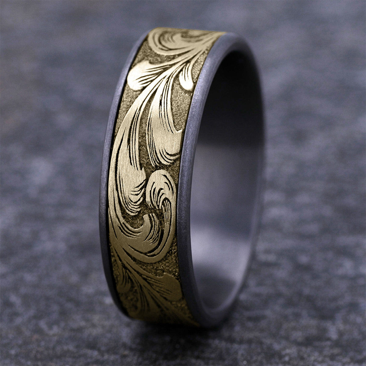 Men's 7.5mm Barrel Script Wedding Ring in Gray Tantalum & 14K Yellow Gold close-up detail